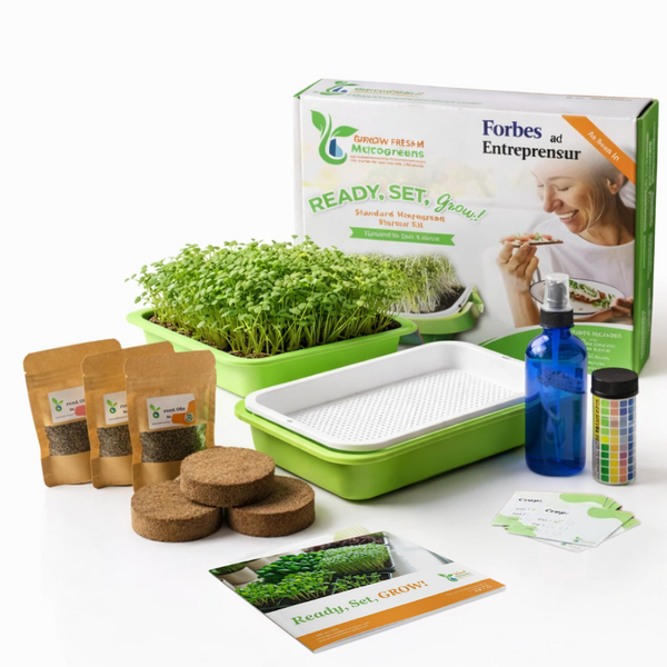Microgreens growing kit with sprout tray, seeds, and accessories on a white background