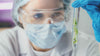 Scientist studying microgreens in a vial
